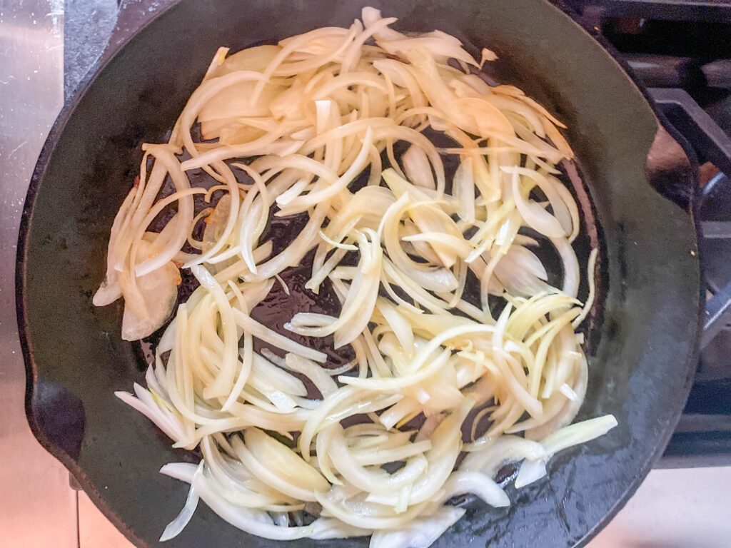 Creamy Pasta with Vegetables, sliced onions in skillet