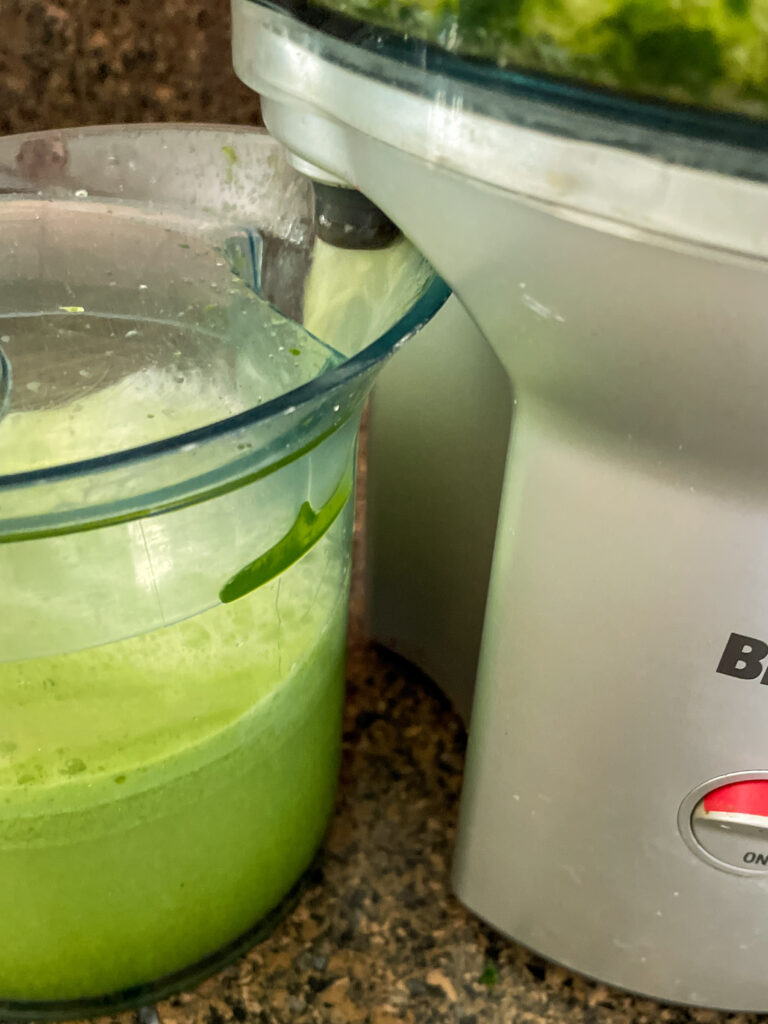 Kale Cooler Recipe, green juice coming out of a Breville Centrifugal Juicer