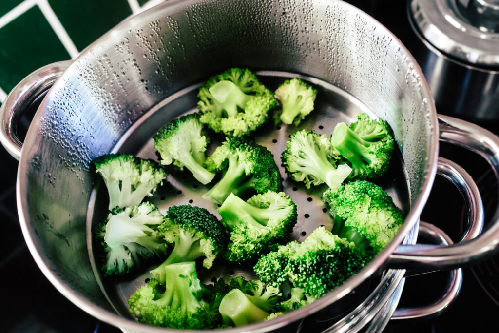 Broccoli in a steamer, Broccoli florets being cooked in a steamer